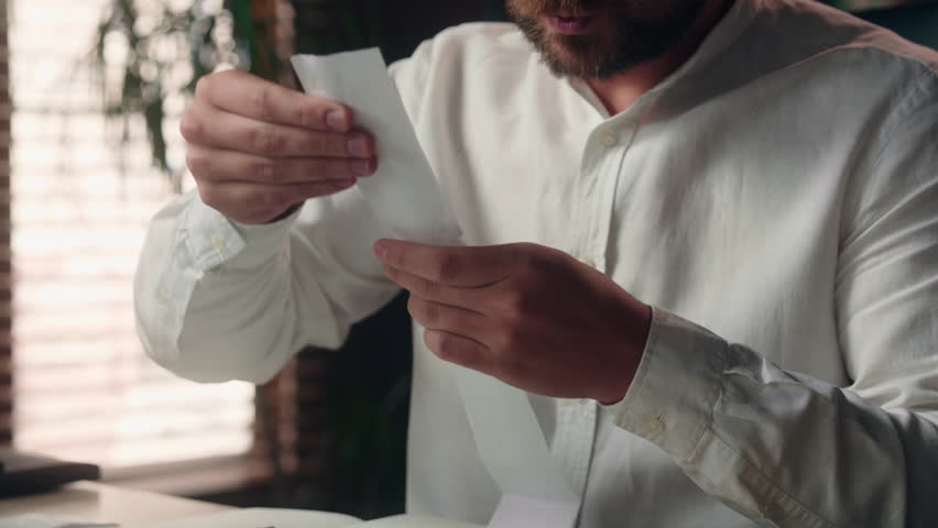 Stressed Caucasian business man salesman ceo manager holding bill finance leader businessman male read payment bills in office executive employer guy calculate financial expense price fee banking fine