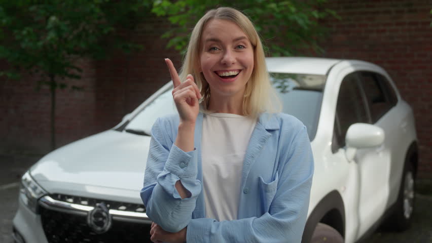 Puzzled pensive Caucasian female automobile owner vehicle driver girl think wonder seeking solution car breakdown problem businesswoman contemplate in city woman raise finger smile idea auto decision