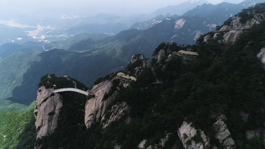 Aerial view of mountain peaks with tourists on the plank walkway