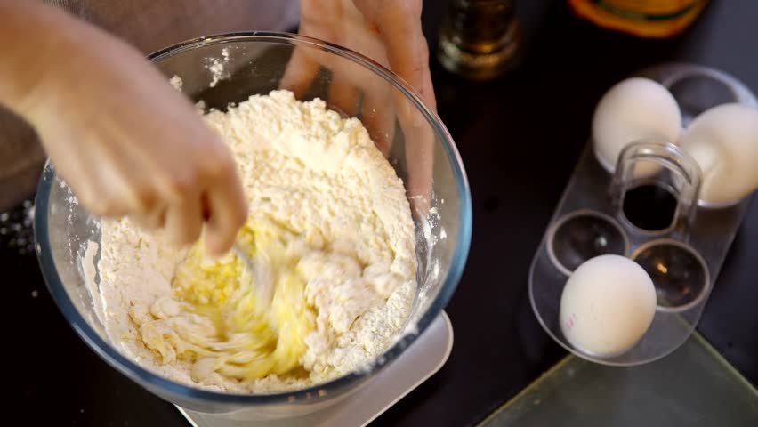 Cook Mixes Flour With Eggs For Pancake. Preparing Breakfast In Home Kitchen. Kneading Dough With Whisk For Baking Cake. 
Chef Cook Dessert Mixing Dough. Pancake Culinary. Whisk Mixing Dough For Baking