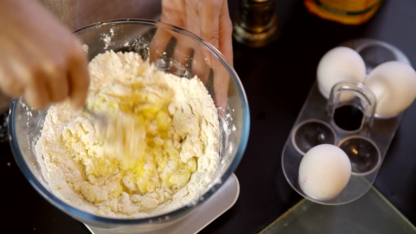 Cook Mixes Flour With Eggs For Pancake. Preparing Breakfast In Home Kitchen. Kneading Dough With Whisk For Baking Cake. 
Chef Cook Dessert Mixing Dough. Pancake Culinary. Whisk Mixing Dough For Baking