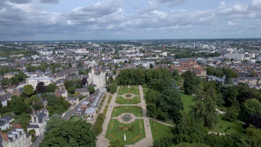 Amazing panoramic drone movement backwards towards the botanical garden of Parc du Thabor and citsycape, Rennes, Bretagne in France.