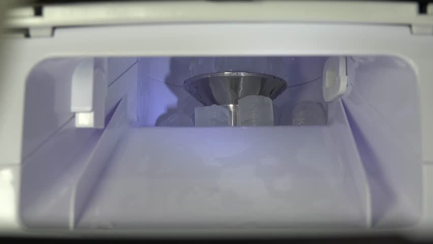 Closeup view of pellet ice maker as ice breaks into pellets and falls down hopper. Video is at 3x normal motion. 