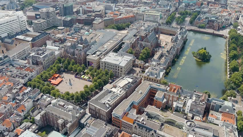 The Hague, Netherlands. Binnenhof. Hofvijver lake in the historical city center. Cloudy weather. Summer day. Stable, Aerial View, Departure of the camera