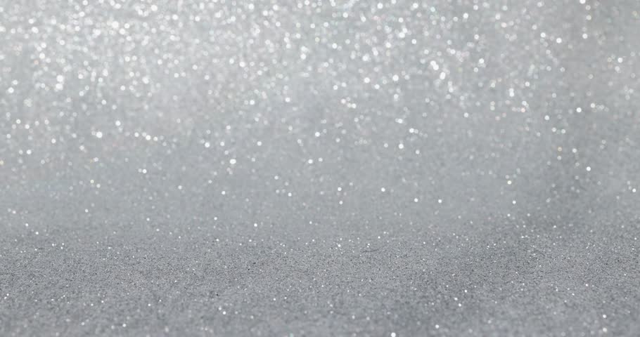 Footage of a red block with a silver glittery background showing the number 1 on a block being put down and taken back up again