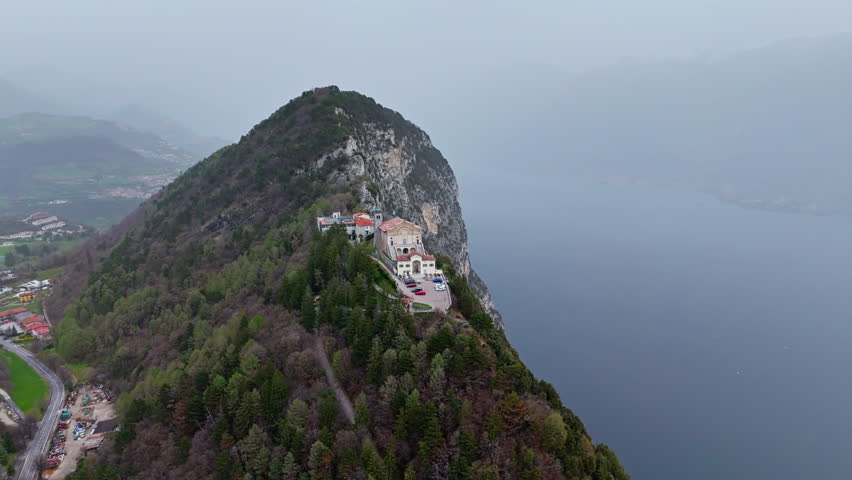 Eremo di Montecastello church on Lake Garda, Italy Lombardia. Aerial orbital flightt