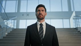 Smiling ceo pointing finger to camera on corporate office stairs. Happy businessman standing on company staircase in elegant suit. Successful man business owner expressing leadership in modern hall. - Powered by Shutterstock - Get 15% off with code: PIKWIZARD15