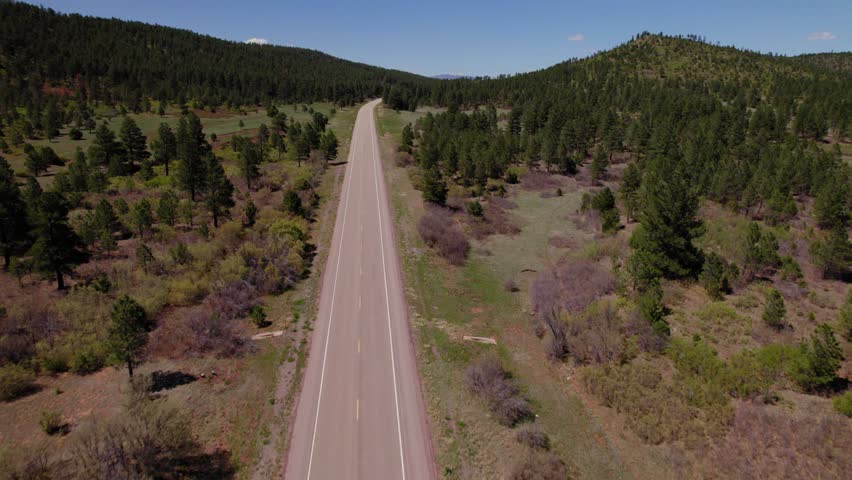 Soaring Over a Remote Open Road Leading to the Mountains