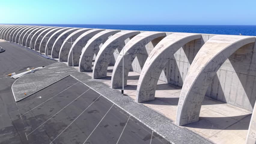 Aerial views revealing architectural arches in Tazacorte, La Palma, framing dramatic ocean landscapes with geometric precision and vivid blue waters
