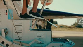 Walking down stairs of private plane onto red carpet, close up tracking shot of man with backpack flying and exiting aircraft in 4k - Powered by Shutterstock - Get 15% off with code: PIKWIZARD15