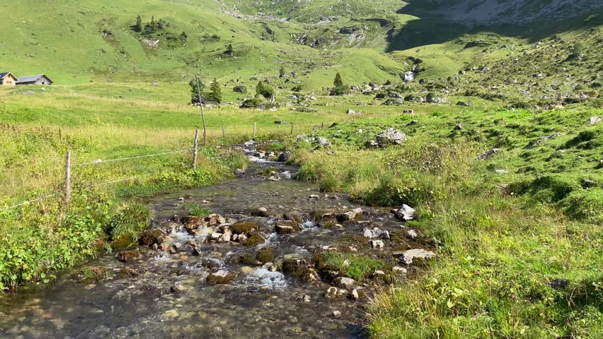 Pristine mountain brook flowing among stones at Bannalp, Switzerland