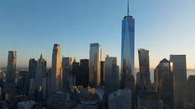 Aerial view of sun rising over the New York City skyline, casting long shadows from skyscrapers of Financial District of Lower Manhattan, including One World Trade Center - Powered by Shutterstock - Get 15% off with code: PIKWIZARD15
