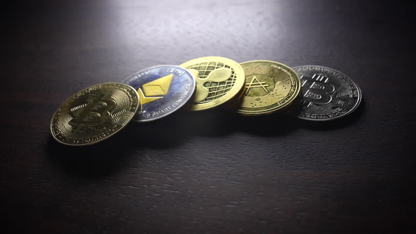 A Wide Array of Diverse Cryptocurrency Coins Displayed on a Dark Background Surface