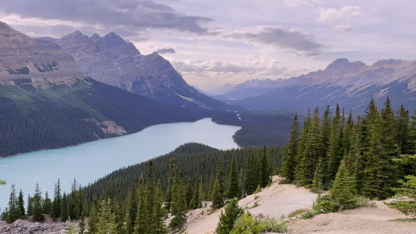 Breathtaking view of Peyto Lake’s turquoise waters nestled among the rugged peaks of the Rocky Mountains in Banff National Park, Alberta, Canada, zoom in