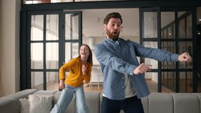 Funny family positive Caucasian guy dad father dancing together with happy little kid daughter girl at home child schoolgirl daddy parent man having fun male singing song dance bonding love childcare - Powered by Shutterstock - Get 15% off with code: PIKWIZARD15