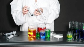 Scientist conducting experiment with colorful liquids - Powered by Shutterstock - Get 15% off with code: PIKWIZARD15