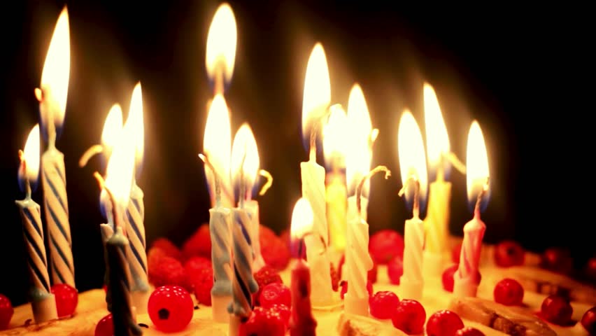 Burning birthday candles with black background color 6k footage