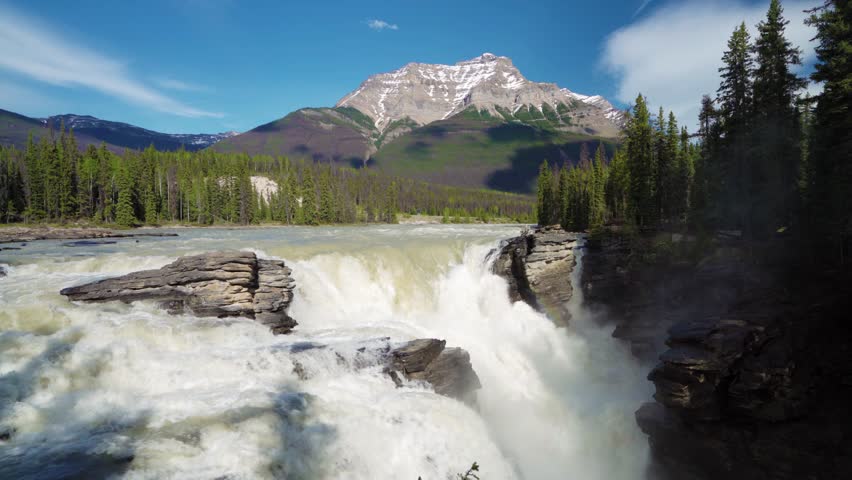 Athabasca Falls in Jasper National Park, Alberta, Canada. Canadian Rockies summer landscape. Mount Kerkeslin in the background.