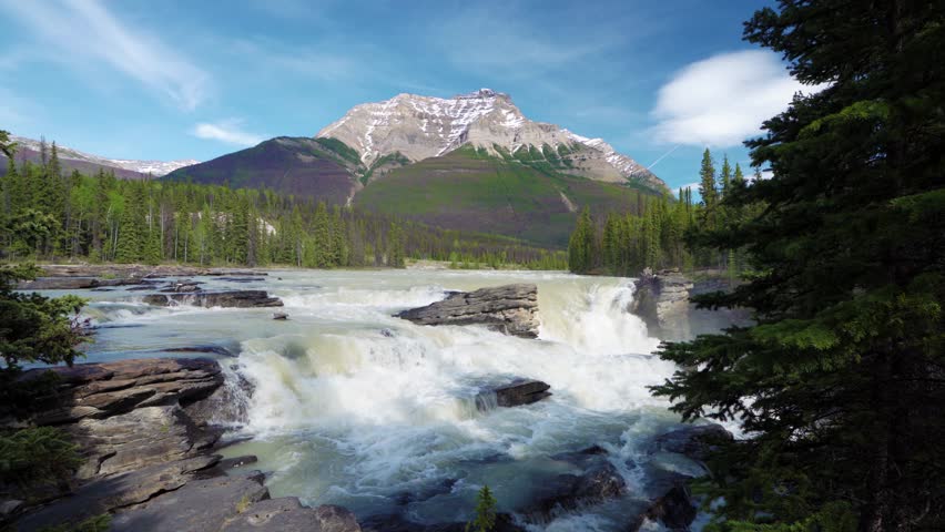 Athabasca Falls in Jasper National Park, Alberta, Canada. Canadian Rockies summer landscape. Mount Kerkeslin in the background.