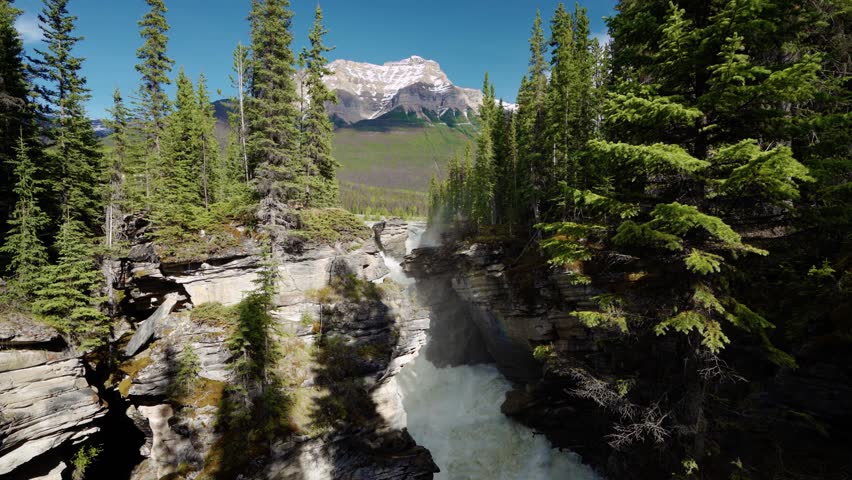 Athabasca Falls in Jasper National Park, Alberta, Canada. Canadian Rockies summer landscape. Mount Kerkeslin in the background.