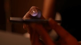 Close-up hands of unrecognizable woman scrolling and tapping on smartphone screen in dimly lit room. Female late-night mobile phone usage and engagement with online content. Shooting in slow motion. - Powered by Shutterstock - Get 15% off with code: PIKWIZARD15