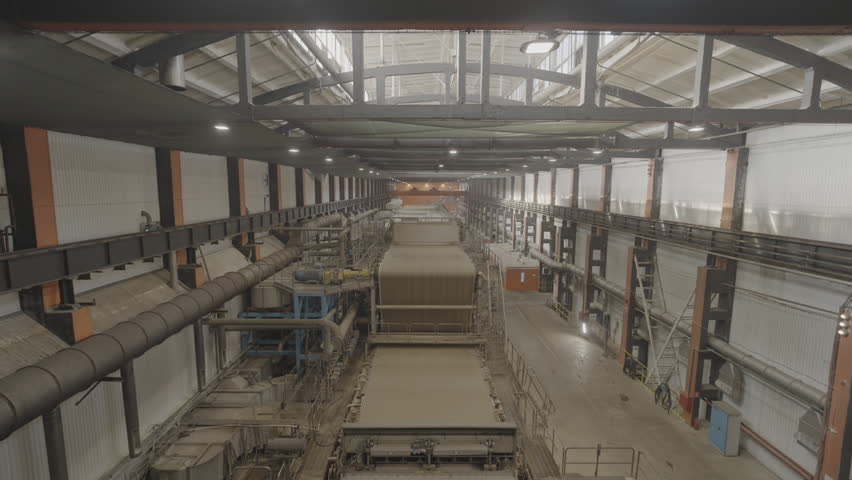 Hall with conveyor of transporting raw paper for further processing. Building with mechanism for delivering material to pressing department