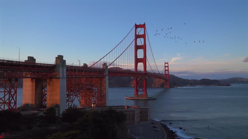Surfing Golden Gate Bridge San Fransisco California at Bay Area Fort Point National Historic site Battery vista point sunset dusk Welcome Center Pacific Ocean birds in V flight static shot