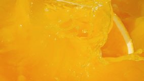 Oranges slices splashing into bright orange juice, creating vibrant waves and ripples in slow motion 300fps - Powered by Shutterstock - Get 15% off with code: PIKWIZARD15