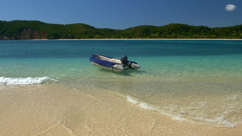 Madagascar coastline, sandy beach, ocean and boats.