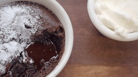 Delicious Chocolate Lava Cake with Powdered Sugar and Whipped Cream on Wooden Plate - Powered by Shutterstock - Get 15% off with code: PIKWIZARD15