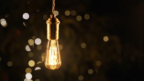 Decorative Old Edison Tungsten Filament Lamp Hanging Outdoors In Garden, Glowing - Powered by Shutterstock - Get 15% off with code: PIKWIZARD15