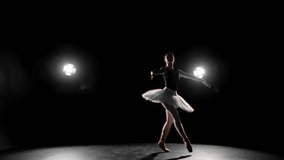 Fascinating ballet performance, beautiful ballerina jumping on dark stage. Beautiful and passionate woman in white tutu dancing by classical music, professional ballet dance performer, art and hobby - Powered by Shutterstock - Get 15% off with code: PIKWIZARD15