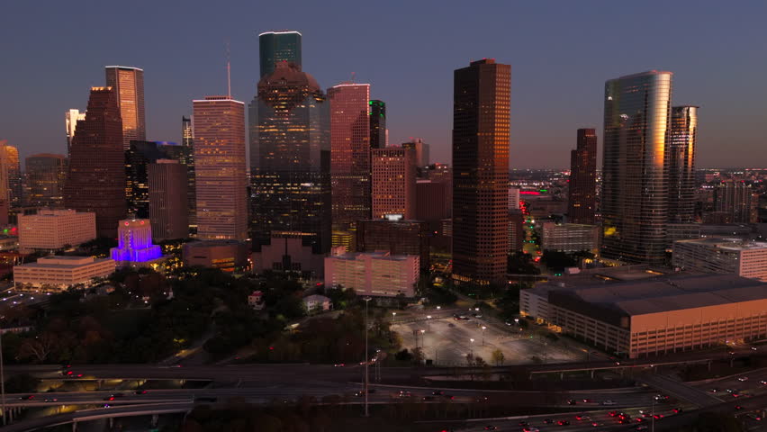 Breathtaking aerial shot of Houston, Texas, highlights colorful skyline that beautifully stands out against a stunning sunset backdrop, creating a picturesque cityscape with car freeway interchange  - Powered by Shutterstock - Get 15% off with code: PIKWIZARD15