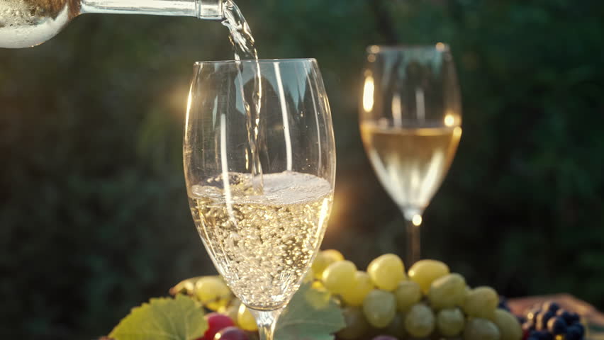 Beautiful View Of White Wine Poured Into Wineglass On Summer Terrace Of Nature