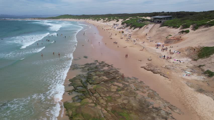 Locals And Tourists At The Soldiers Beach In Summer in Norah Head, NSW, Australia.- aerial shot