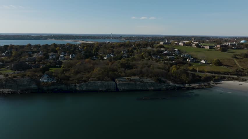 Aerial of New England beach town on rocky cliff in autumn on a sunny day in Newport Rhode Island outskirts