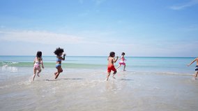 Happy Children travel playing at the sea on summer beach holiday vacation. Group of Little cute child boy and girl kid enjoy and fun outdoor lifestyle running and playing in the sea at tropical island - Powered by Shutterstock - Get 15% off with code: PIKWIZARD15