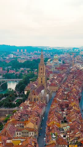 Vertical video. Bern, Switzerland. Bern Cathedral. Panorama of the city with a view of the historical center. Summer morning, Aerial View, Point of interest. Rich colors