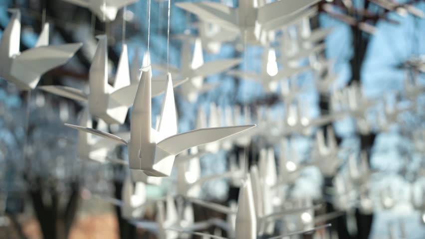 Origami cranes hanging from a string. It symbolize peace, hope, longevity, and wish fulfillment.