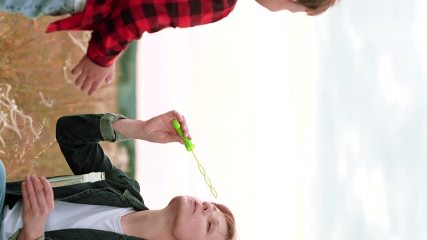 Mother child kid Son Soap Bubbles, happy family, passion game, wind barely noticeable, everything possible, world childhood, air fresh, joy faces, playing together, bubble burst, jeans are comfortable