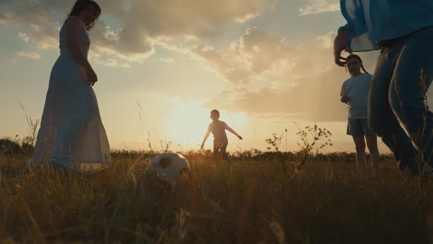 happy family silhouette, mother father child playing ball sunset, family dream, cheerful happy team family, children soccer ball green grass field, childhood nature summer, active child family playing