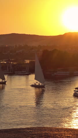 Beautiful view on felucca boats on Nile river in Aswan at sunset, Egypt. Vertical video