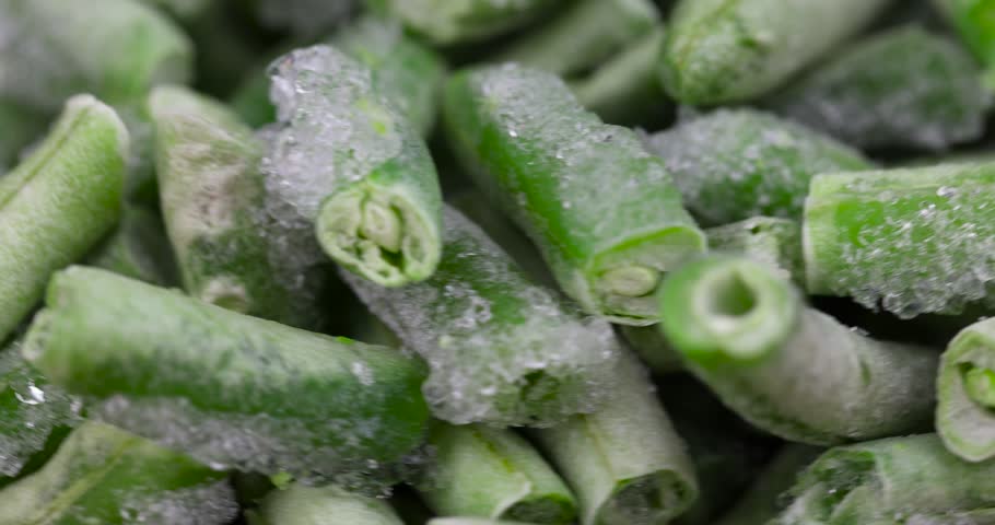 frozen and ice-covered green asparagus beans, frozen beans covered with ice