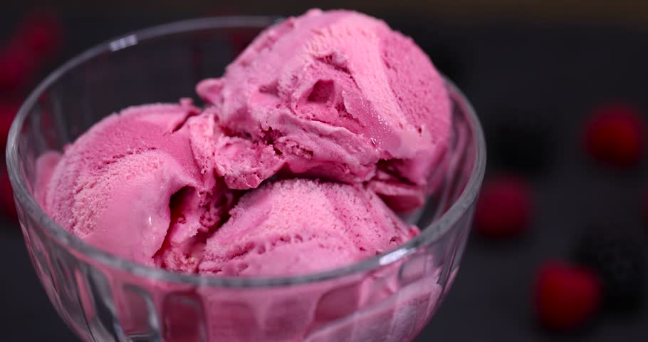raspberry cream ice cream with ripe raspberries and blackberries, delicious ice cream with sugar and raspberry-blackberry flavor with raspberry and blackberry berry jam