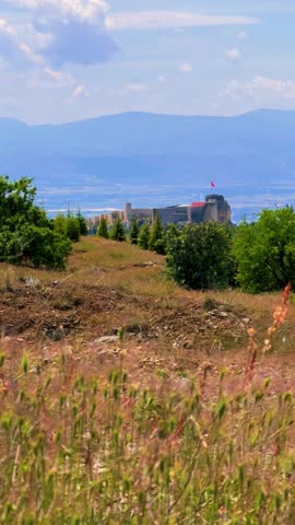 Harput fortress with the Turkish flag, in the spring in Eastern Anatolia, Elazig, Turkey. Harput Castle or Harberd, also known as Sut Kalesi. Ancient city. 4К
