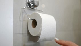 Woman Tears Off A Piece Of Toilet Paper, Roll Hangs In The Toilet - Powered by Shutterstock - Get 15% off with code: PIKWIZARD15