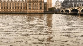 Big Ben and Houses of Parliament stand majestically by the River Thames, framed by Westminster Bridge, slow motion - Powered by Shutterstock - Get 15% off with code: PIKWIZARD15