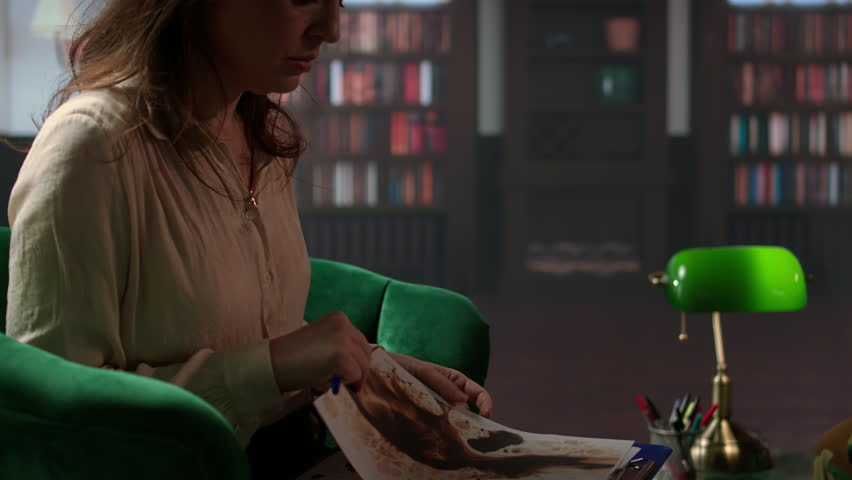 Armed forces veteran in uniform sits with a therapist during counseling, viewing a Rorschach test illustration to share feelings and discuss trauma. PTSD and shell shock syndrome. Camera A.