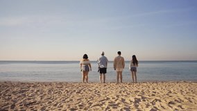 Happy man and woman travel the sea on summer beach holiday vacation. Group of Asian people friends enjoy and fun outdoor lifestyle travel nature walking and playing together at tropical island beach. - Powered by Shutterstock - Get 15% off with code: PIKWIZARD15