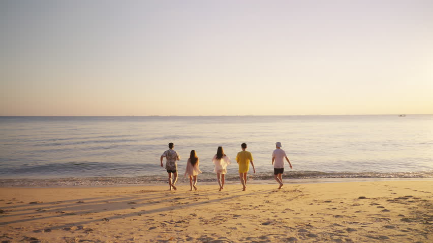 Happy man and woman travel ocean on summer beach holiday vacation. Group of Asian people friends enjoy and fun outdoor lifestyle travel nature playing in the sea together at tropical island beach. - Powered by Shutterstock - Get 15% off with code: PIKWIZARD15